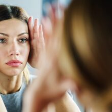 Woman looking into mirror