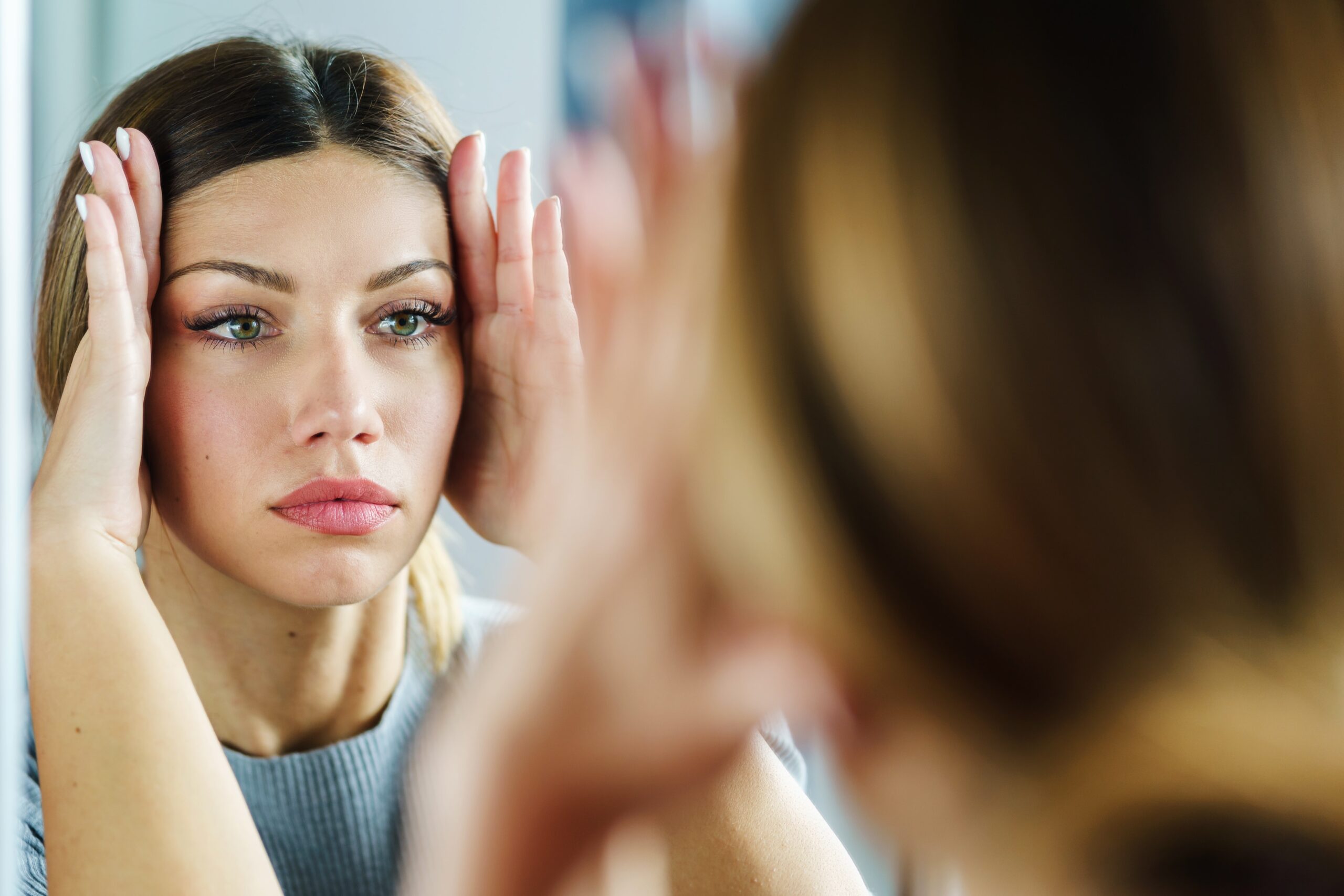 Woman looking into mirror